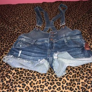 Denim overalls we with tags attached.